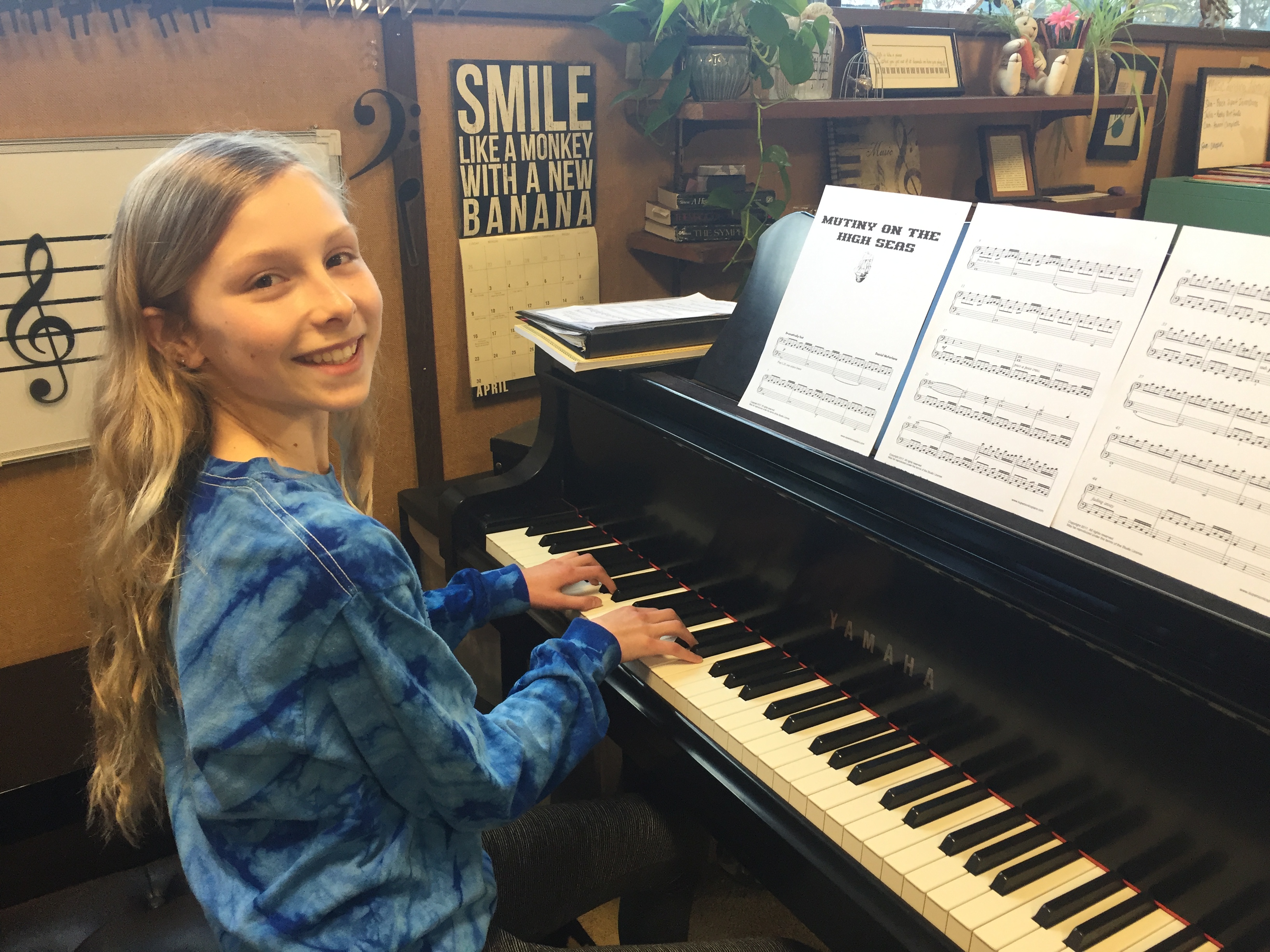 gianna at piano lessons Gianna smiling at the piano with sheet music