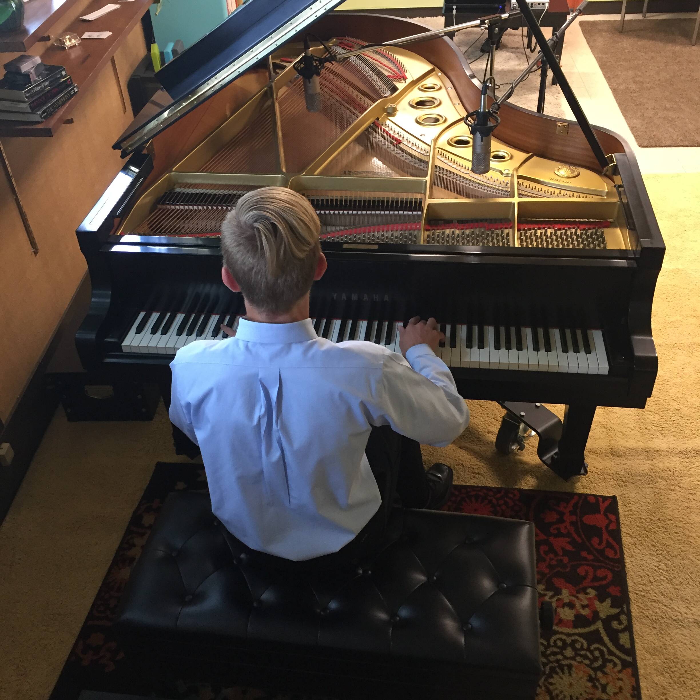 sam video project at piano lessons Overhead view of teen boy playing a grand piano